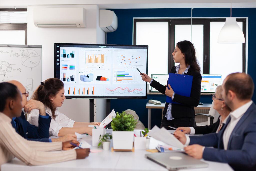 Young Team Leader In Big Corporation Briefing Coworkers Pointing At Graph Meeting Corporate Staff 1024x683